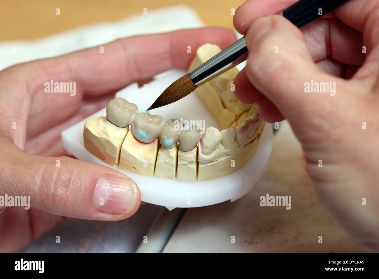 Dental laboratory, dental technician at work, making of tooth bridges