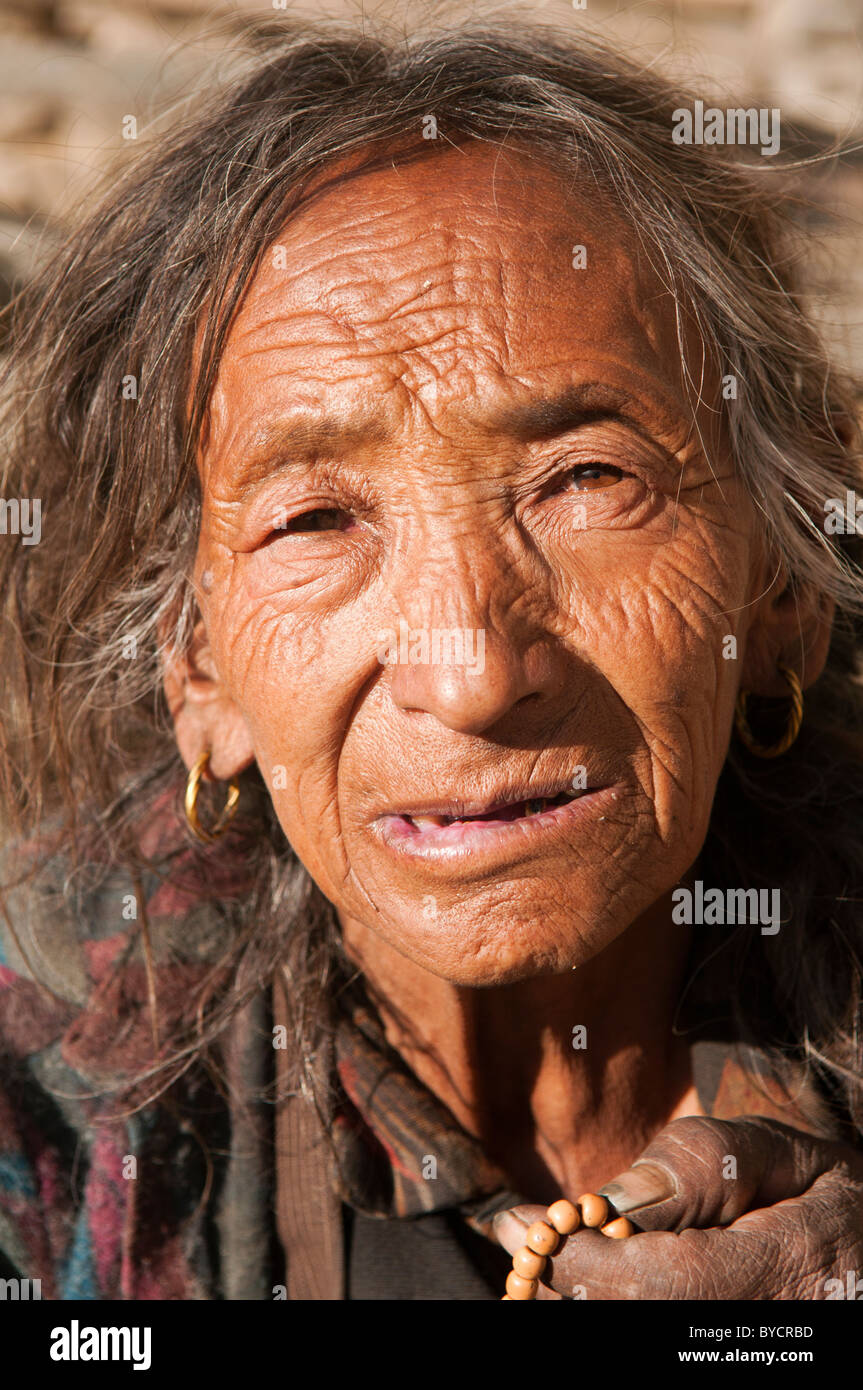 old Tibetan woman in the traditional village of Ghyaru in the Mustang