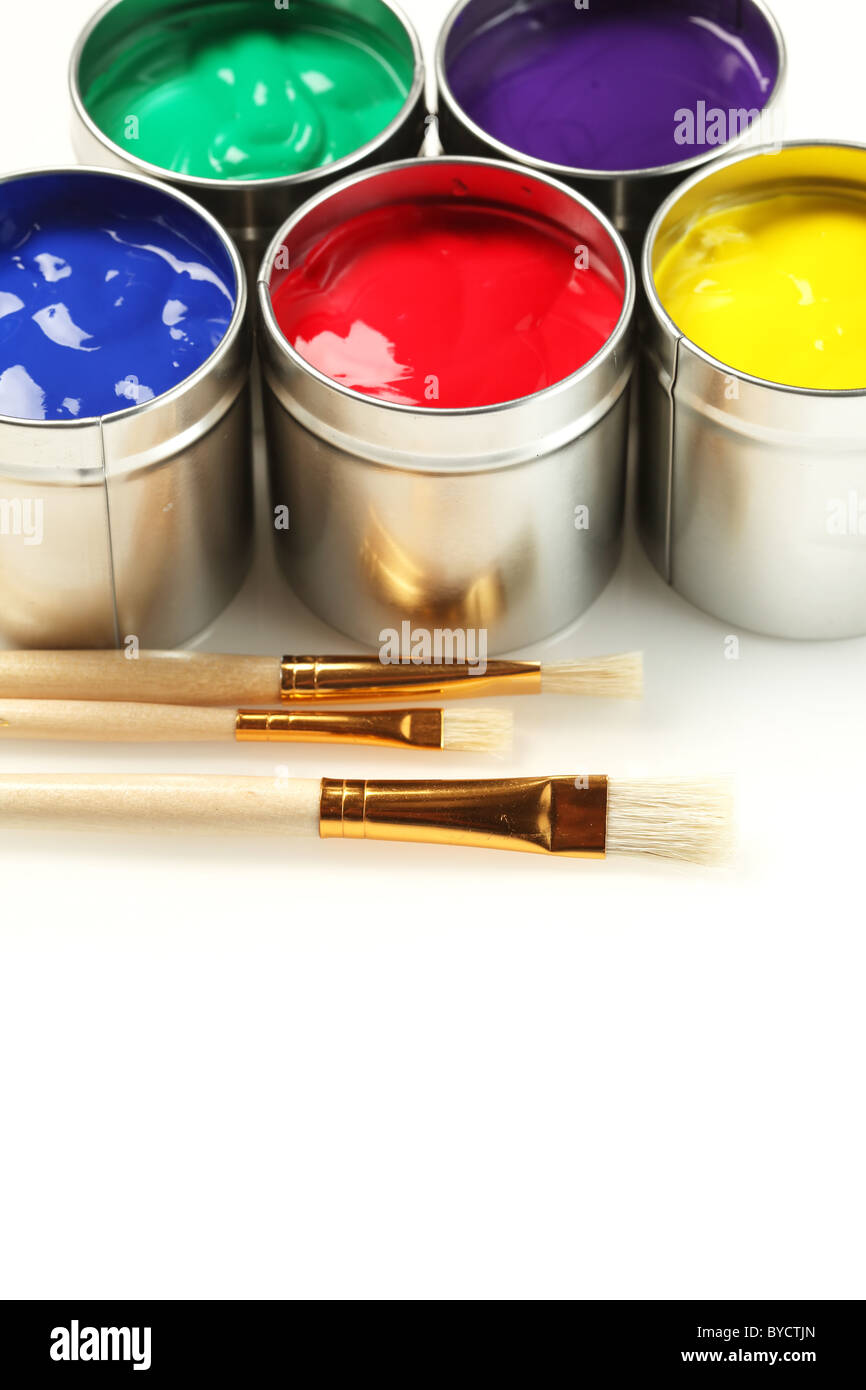 Cans of paint with paintbrushes Stock Photo