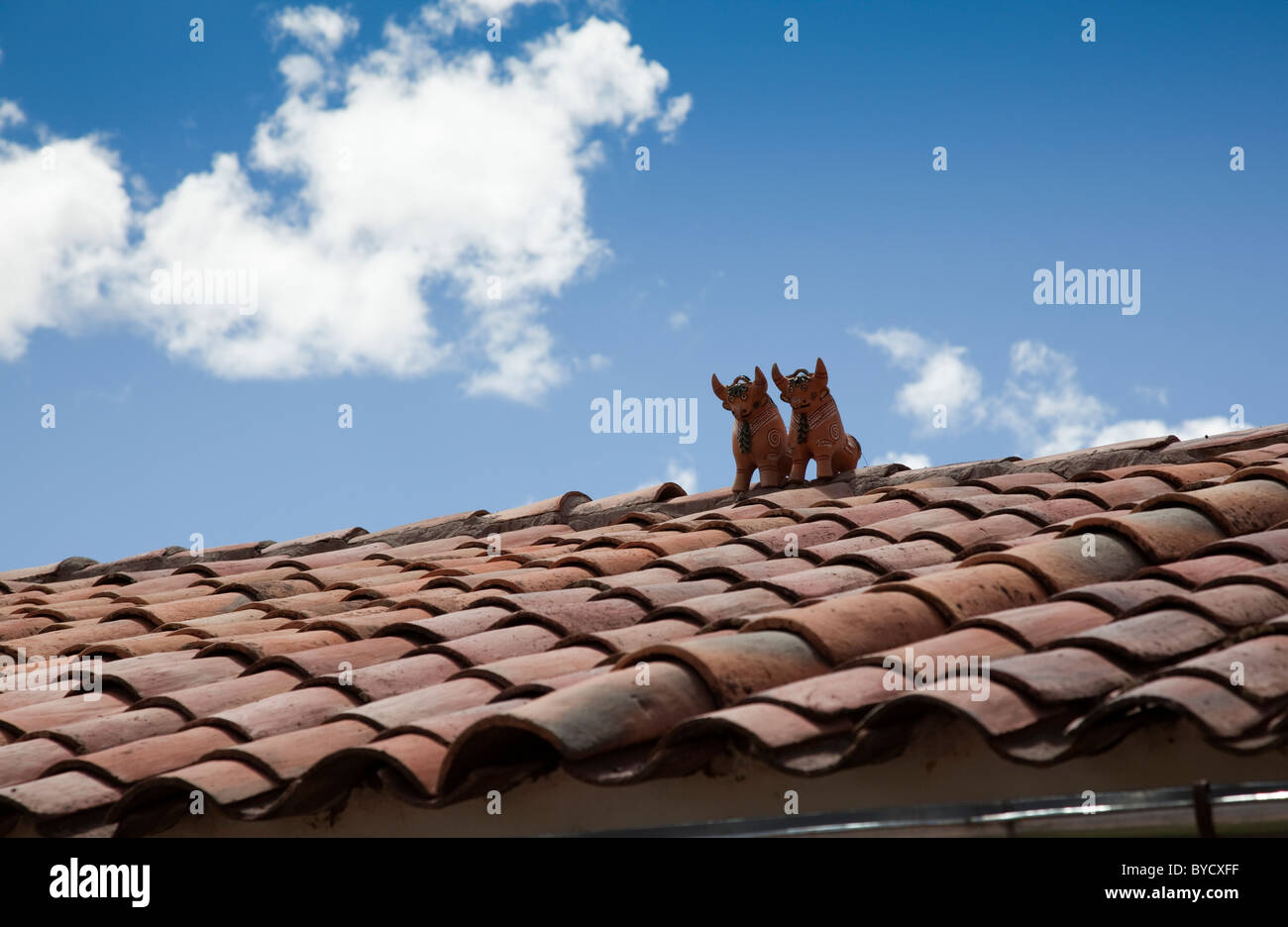 Rooftop twin Pottery Bulls giving good luck to Peruvian houses, Pucara, Peru, South America. Stock Photo