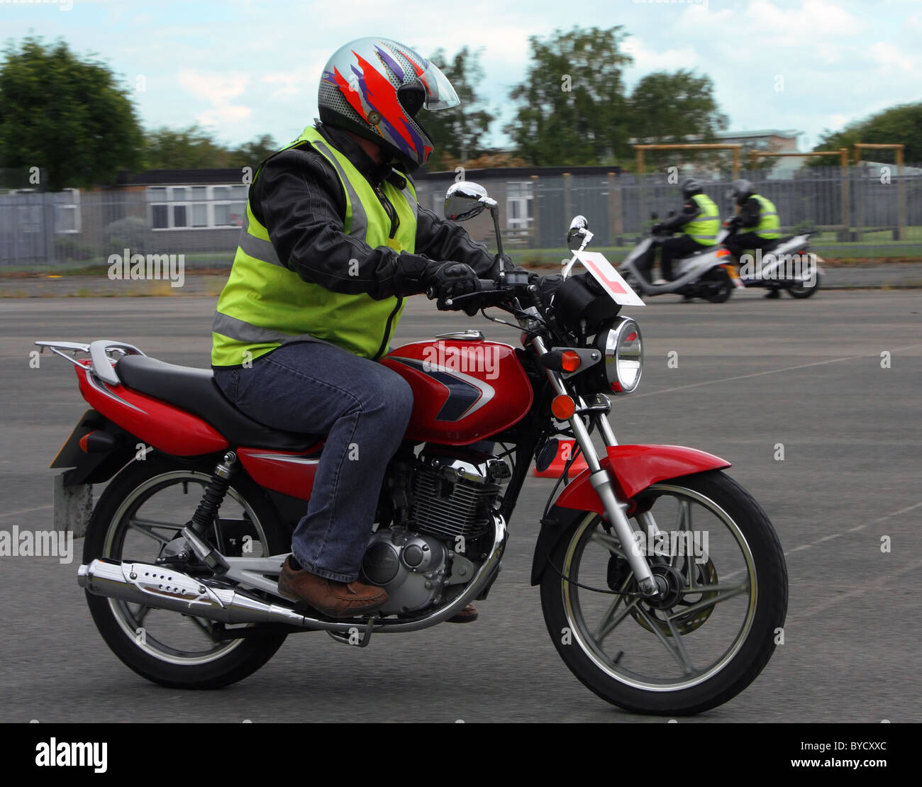 A young learner riding on a 125cc or 50cc motor bike on his CBT training day taking his test Stock Photo