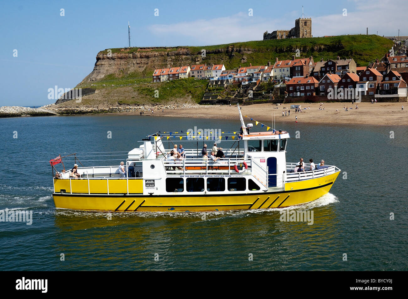 pleasure boat returning to Whitby harbour england uk Stock Photo