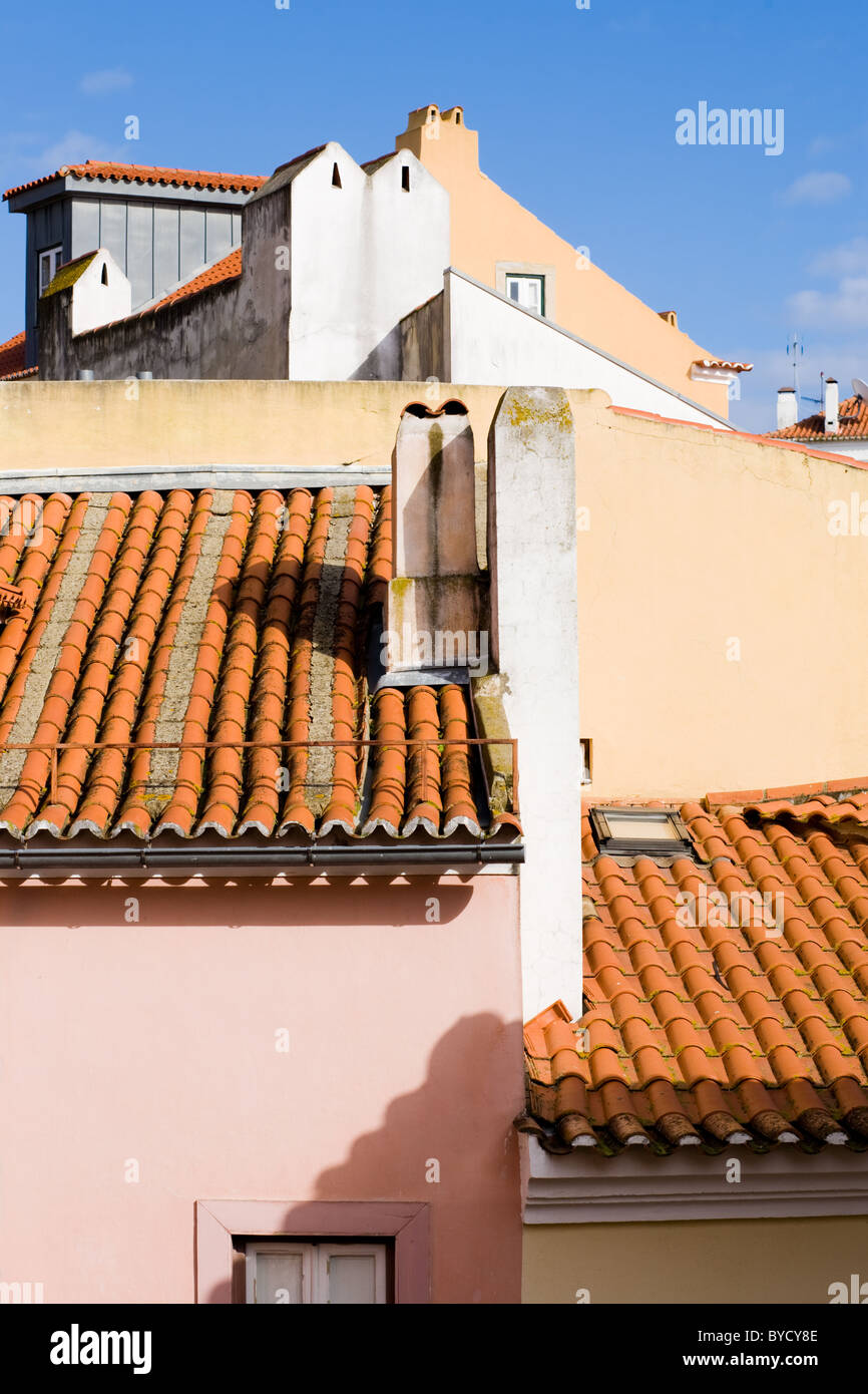 Terra cotta roofs and pastel walls and chimneys, Alfama, Lisbon, Portugal Stock Photo