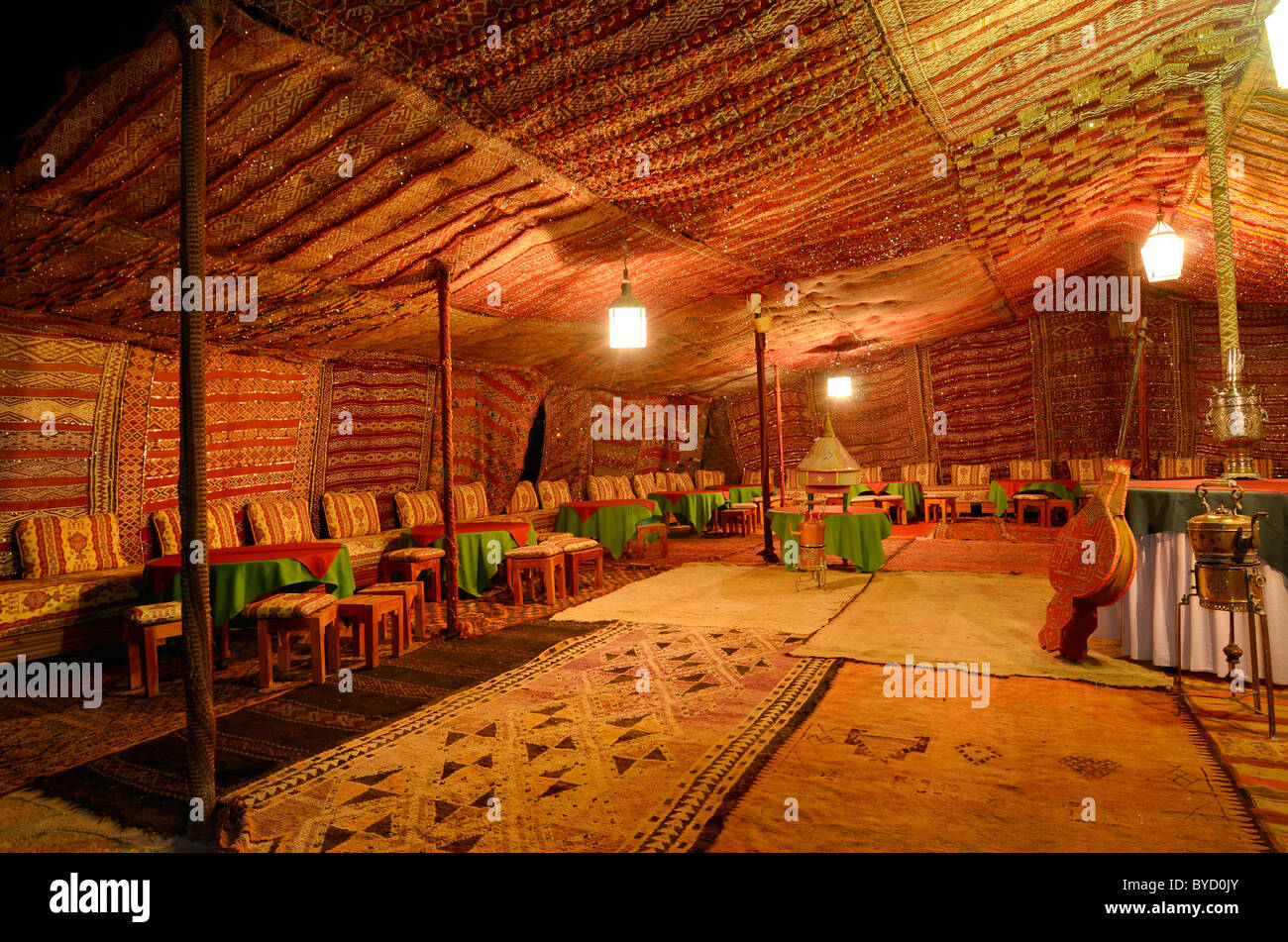 Large empty carpeted Berber tent at night in Tinerhir Morocco Stock Photo