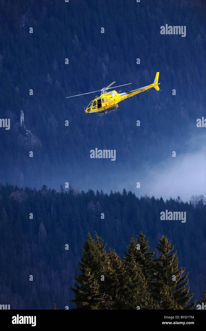 An helicopter in the sky of the Alps Stock Photo