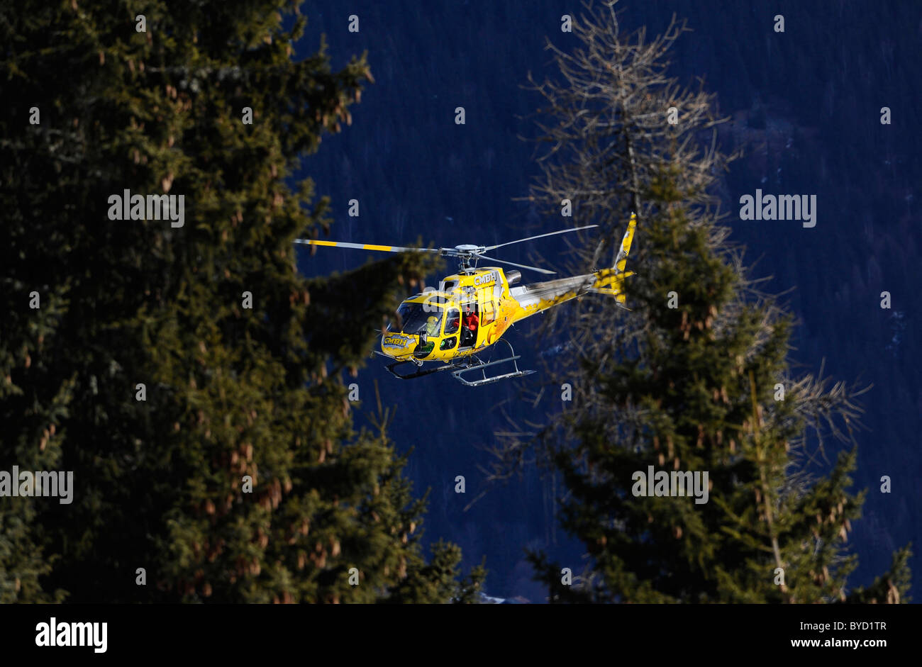 An helicopter in the sky of the Alps Stock Photo
