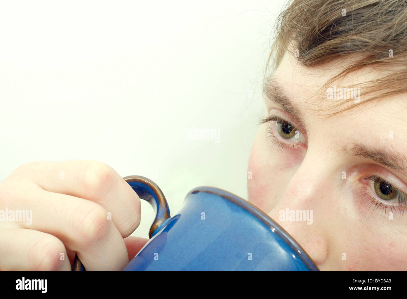 A  close up of a young caucasian man drinking a cup of tea. Stock Photo