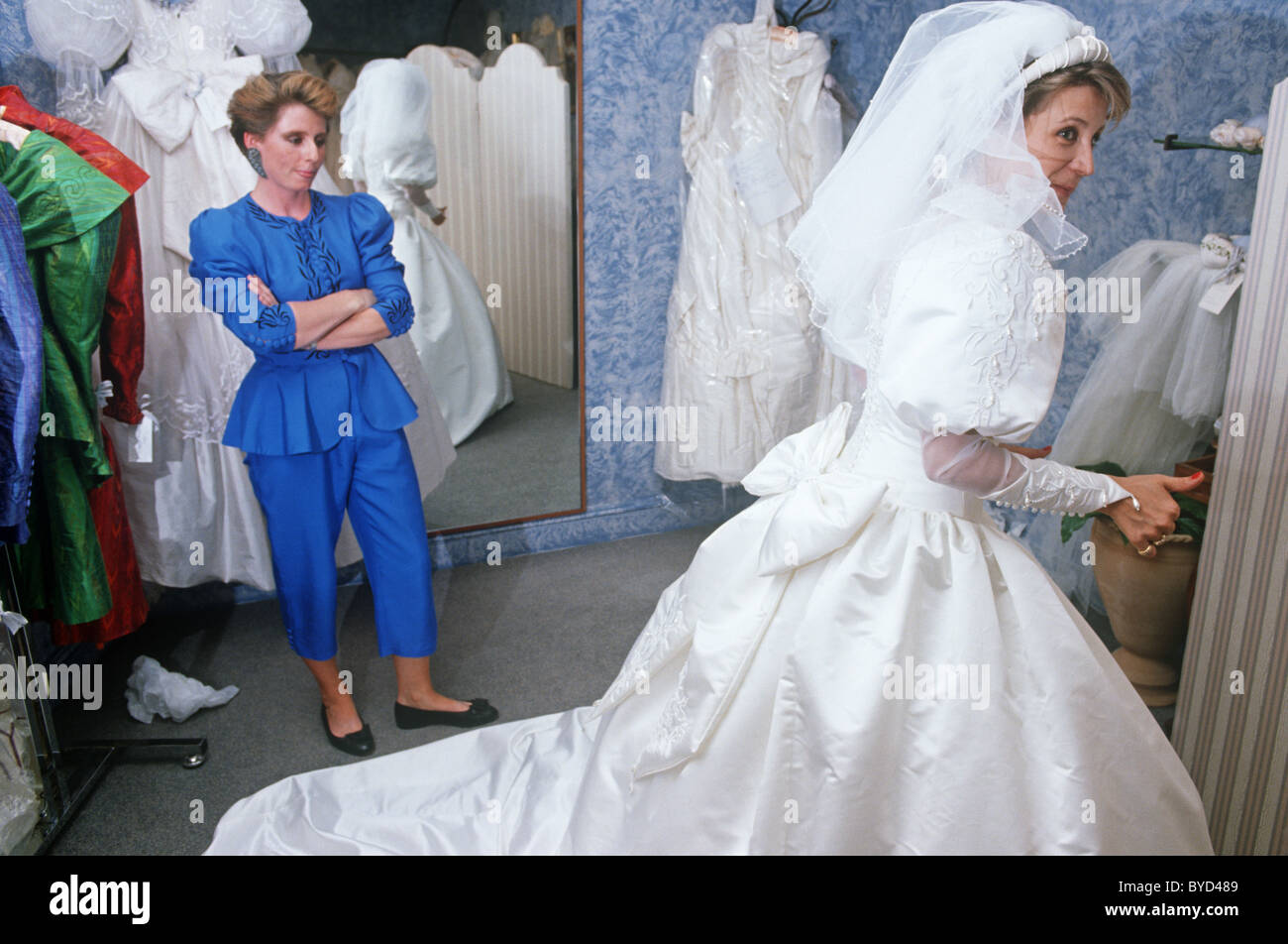 A bridetobe tries on her white wedding dress during a fitting in a London bridal shop Stock