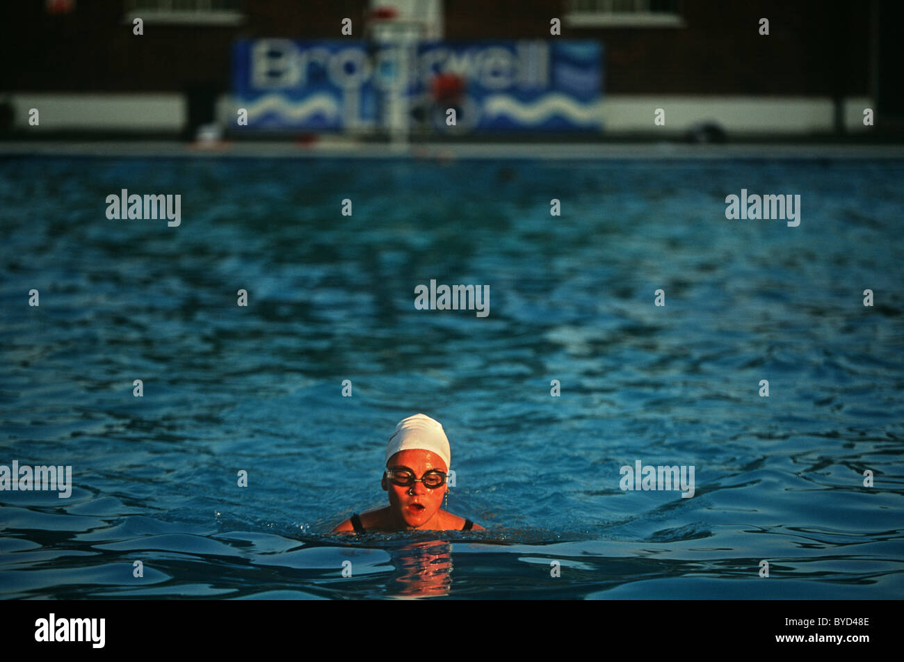 Early morning regular swimmer swims solitary lengths at Brockwell (Brixton) Lido before crowds arrive Stock Photo