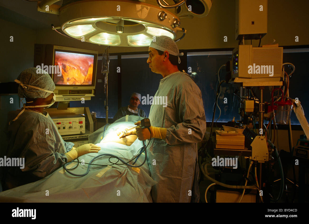 An NHS surgeon performs an operation in a London hospital using