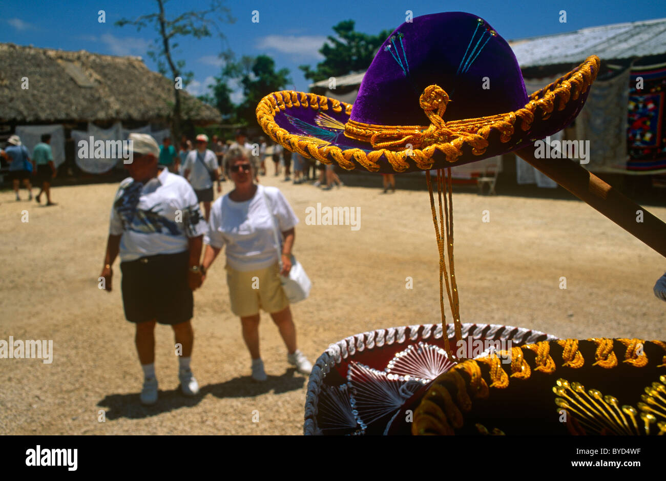 Tourists explore tourist sombrero trinket shops during their cruise ship excursion at Chaccoben Mayan ruins. Stock Photo