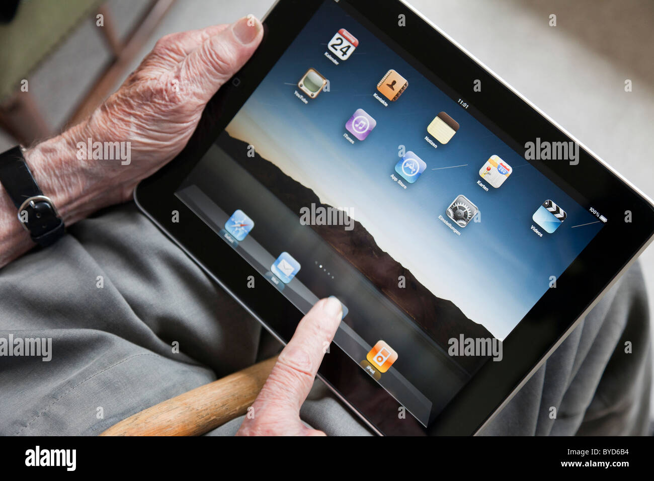 Senior viewing the user interface on an iPad, close-up of his hands Stock Photo