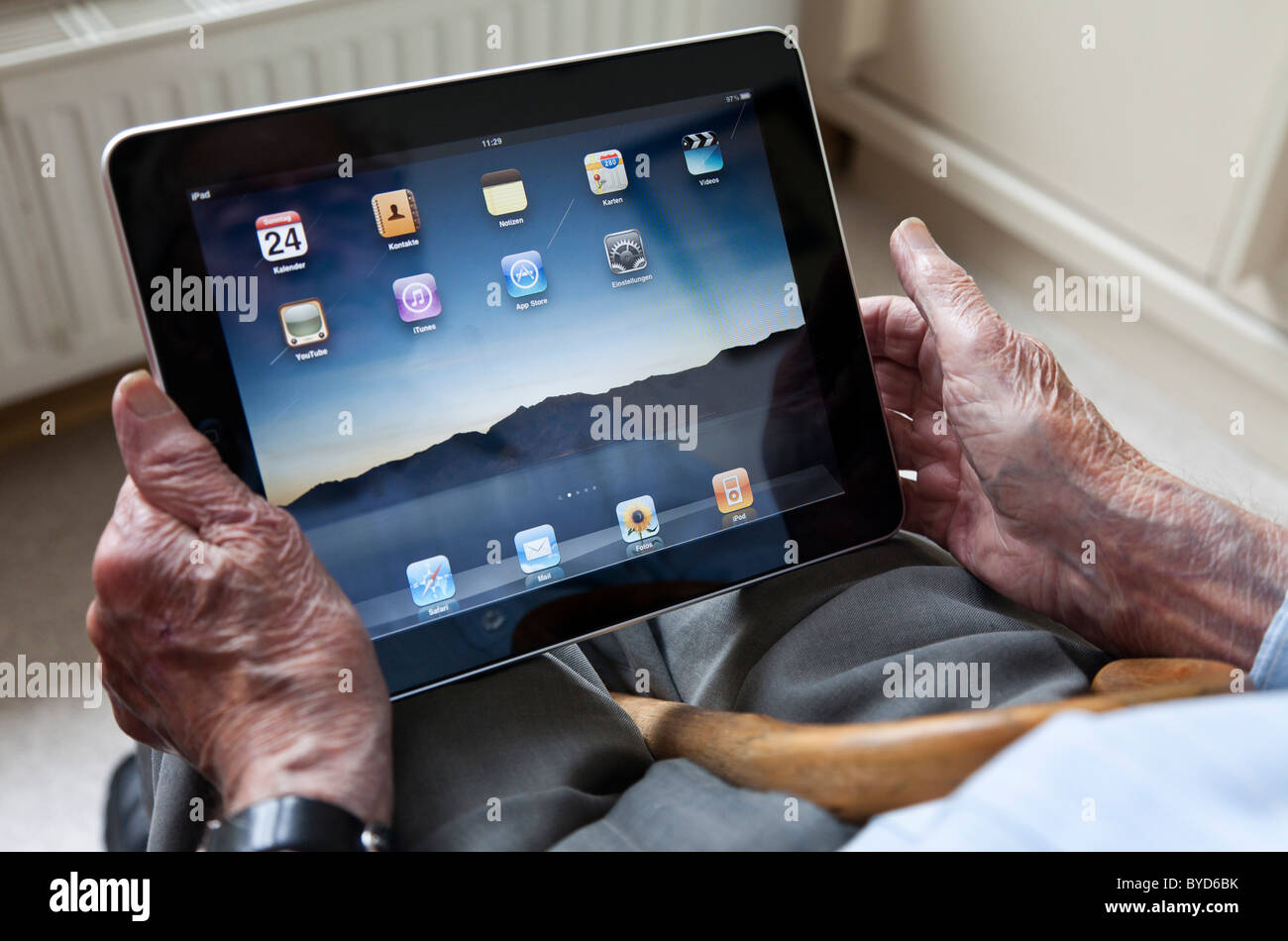 Senior viewing the user interface on an iPad, close-up of his hands Stock Photo