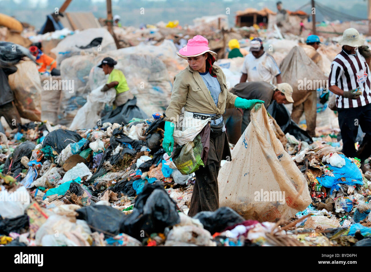 Young woman searching for recyclables at Lixao dump in the satellite city of Estrutural near Brasilia, Distrito Federal, Brazil Stock Photo