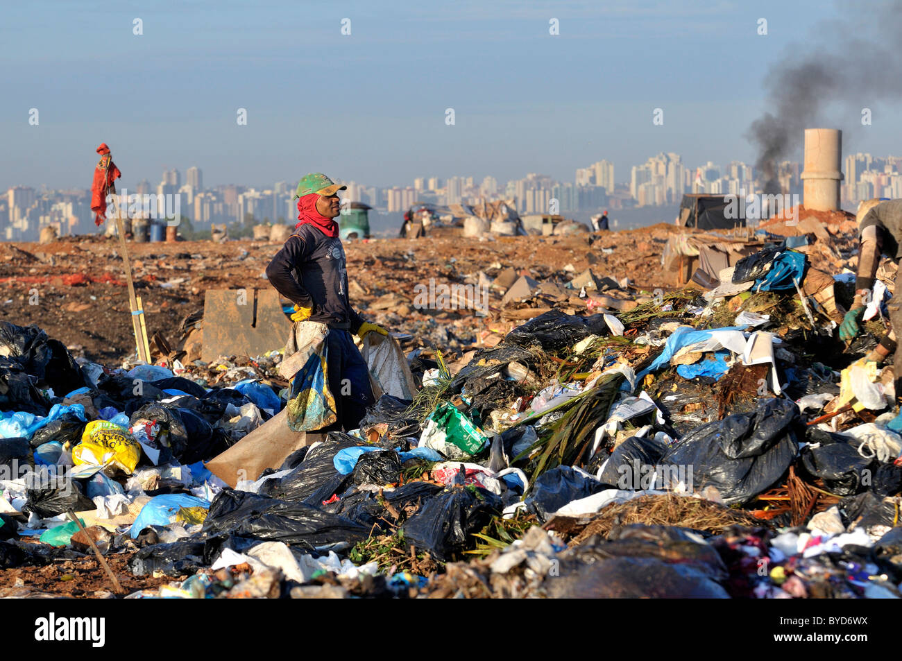 Young man searching for recyclables at the Lixao dump in the satellite city of Estrutural near Brasilia, Distrito Federal Stock Photo