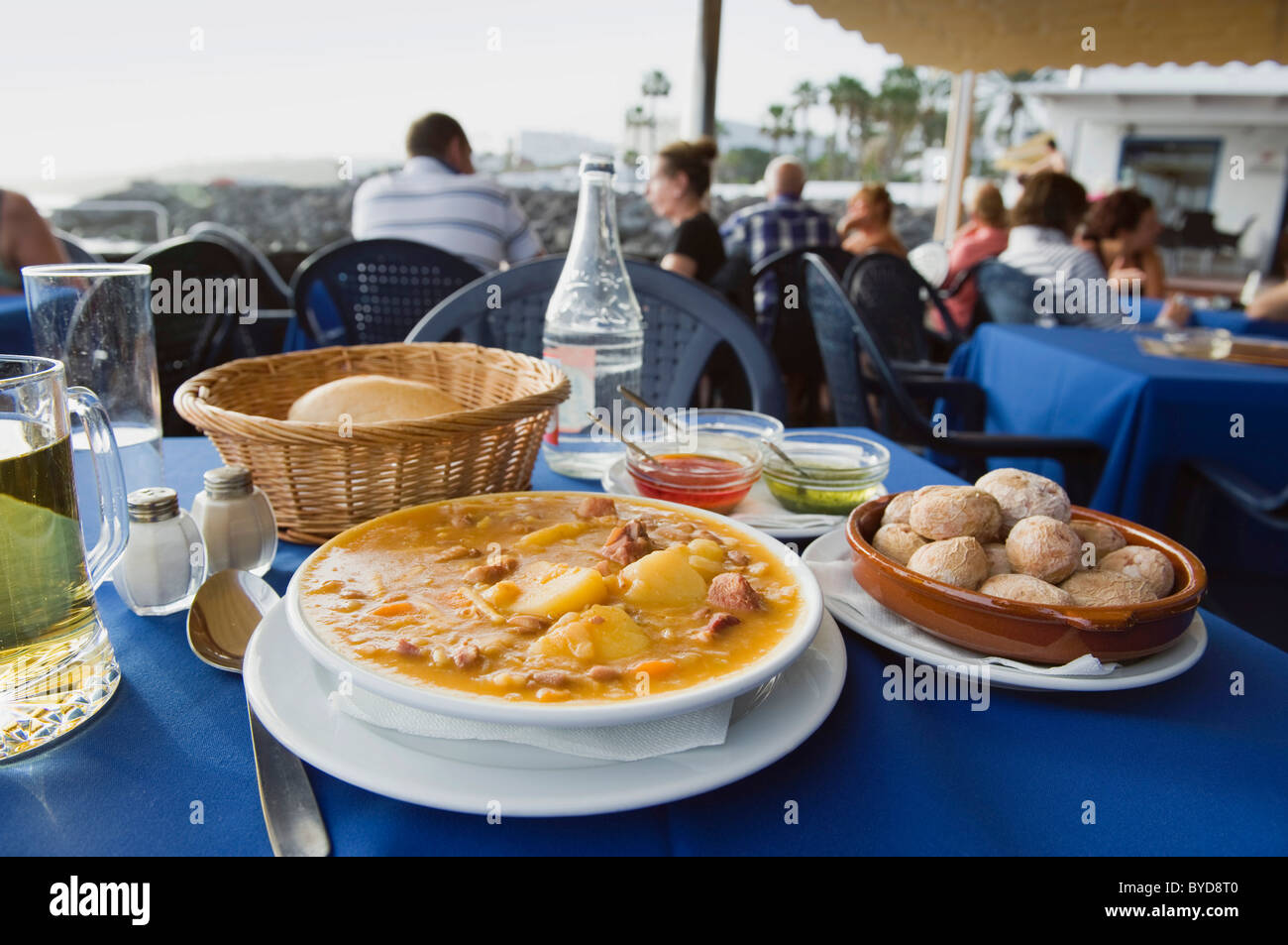 Spanish food in the restaurant, vegetable soup with Canarian potatoes, Papas Arrugadas, Souce Mojo Rojo, Mojo Verde, Lanzarote Stock Photo