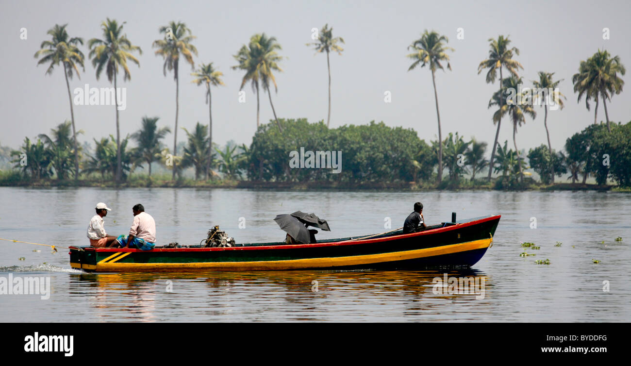 Small ferry on a canal in front of palm trees, Haripad, Alappuzha, Alleppey, Kerala, India, Asia Stock Photo