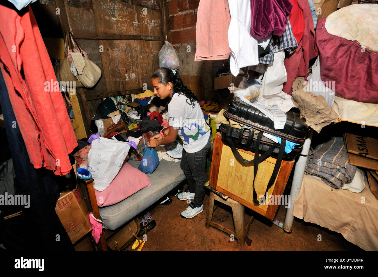 Juvenile, 15, lives with her family in a shabby shack in a Favela or shanty town, her family lives by collecting, separating and Stock Photo
