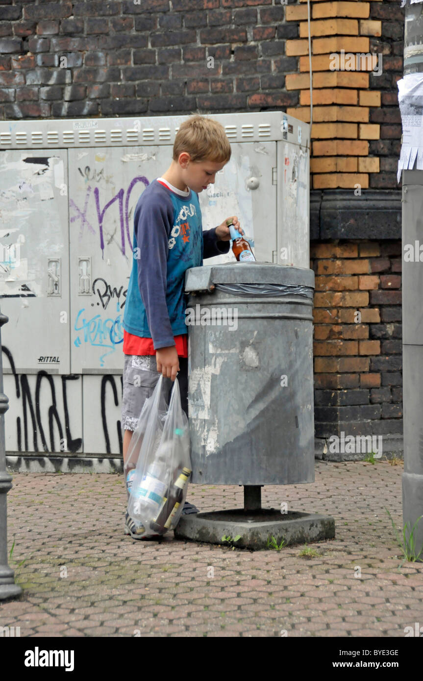 Nine year old boy earning his pocket money by collecting returnable