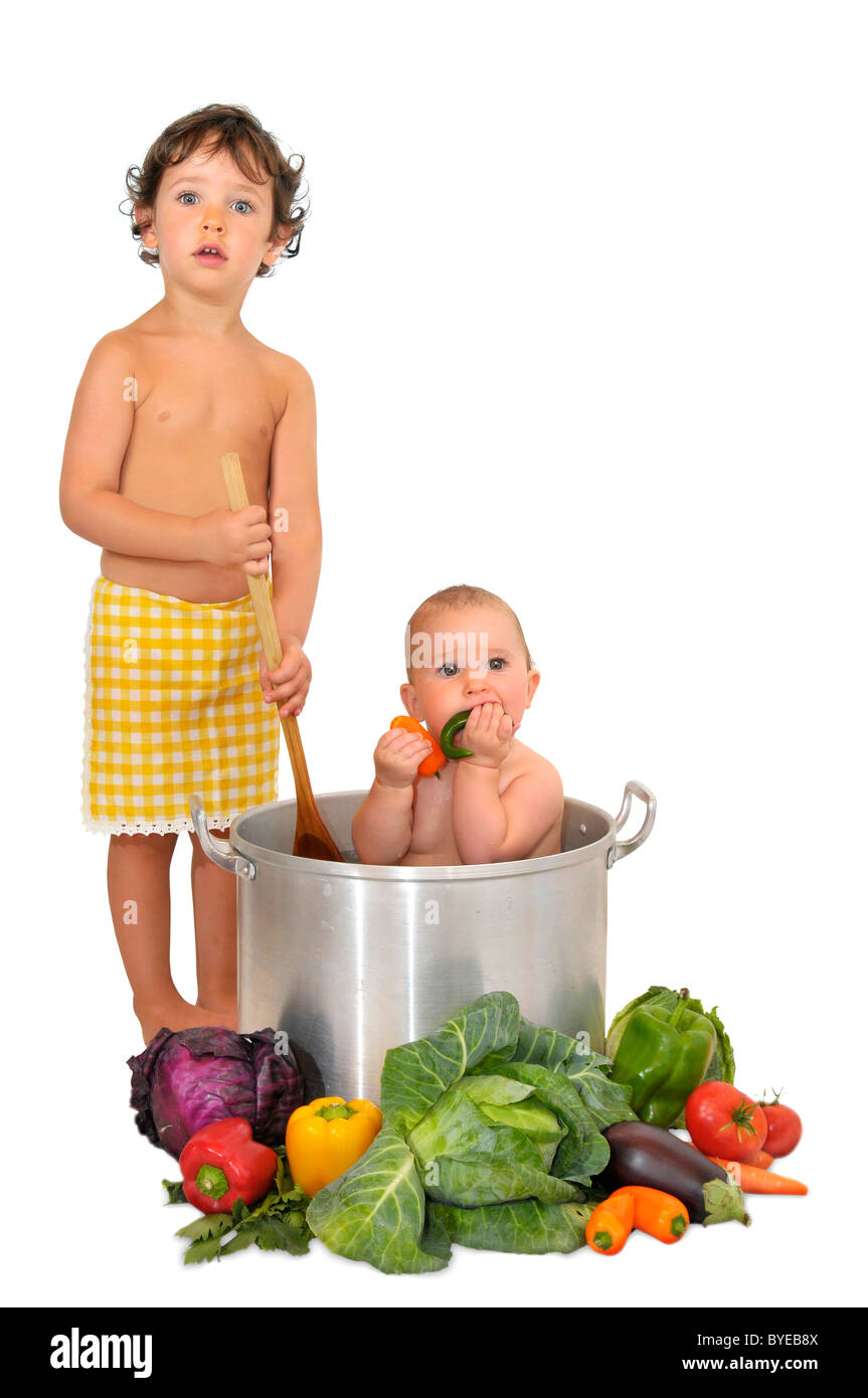 Beautiful young baby in a pan and boy cooking Stock Photo