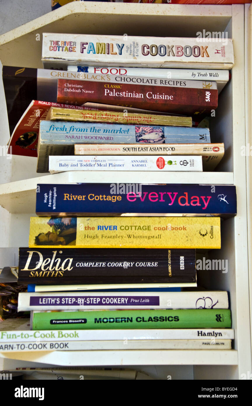 Cookery books stacked on a kitchen shelf Stock Photo Alamy