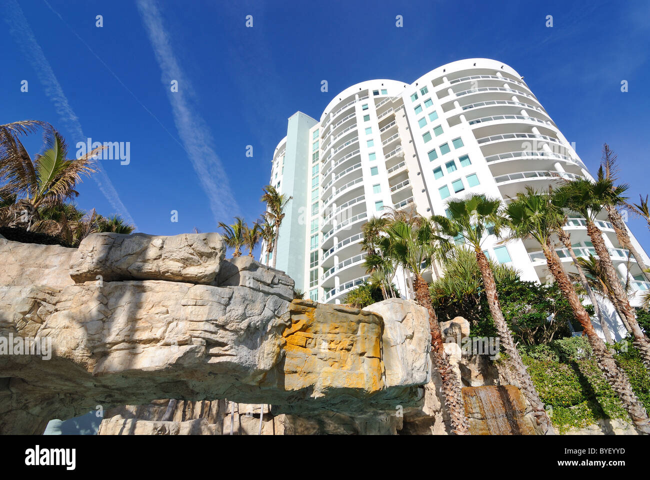 Tropical resort with rock caves and palm trees Stock Photo