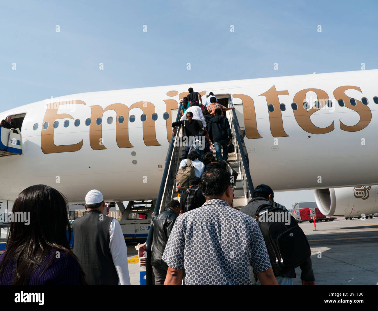 Passengers boarding an Emirates plane Stock Photo Alamy