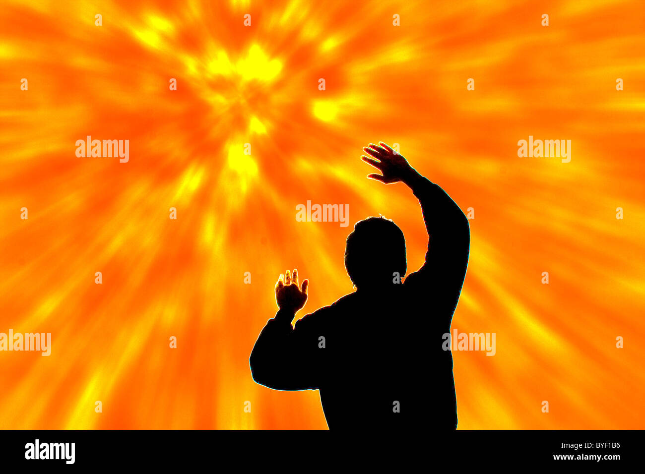 Man struck by yellow and orange beams of light emanating from above Stock Photo