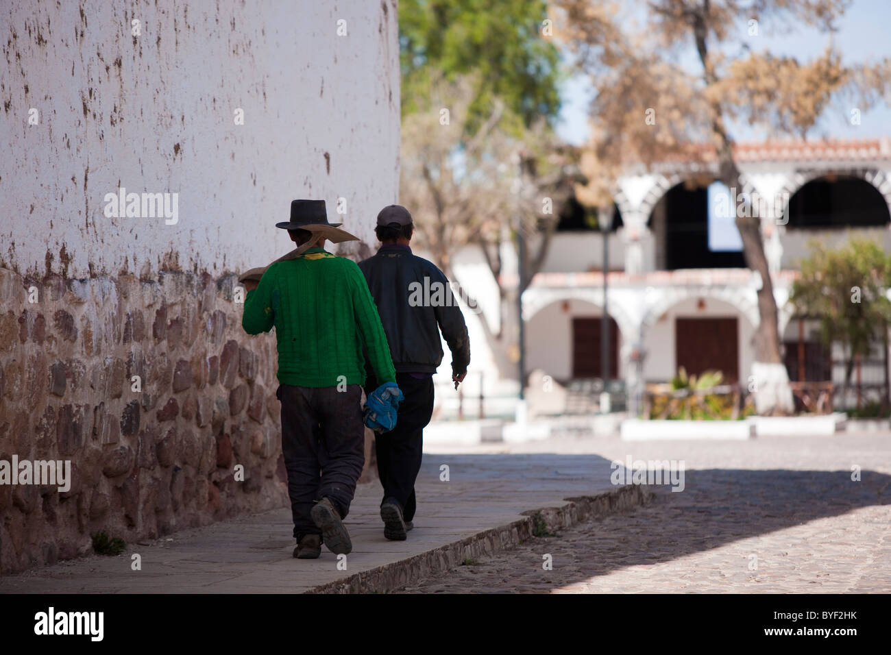 Two men walk to work with thier tools in the small town of Quinua. Quinua is famous for both a historical battle and its potters Stock Photo