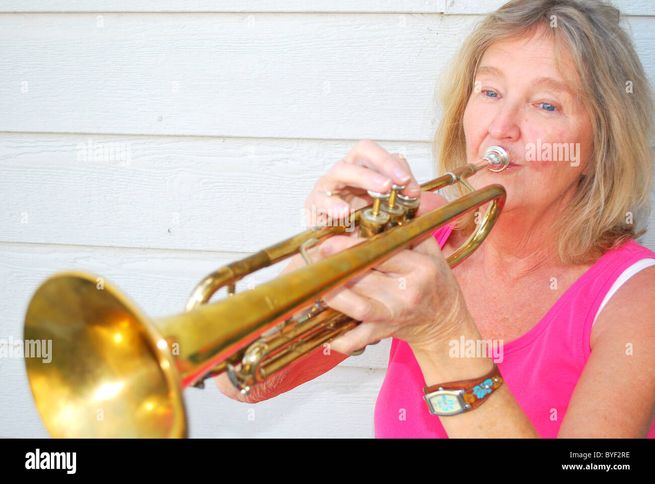 Female trumpet player blowing her horn Stock Photo Alamy