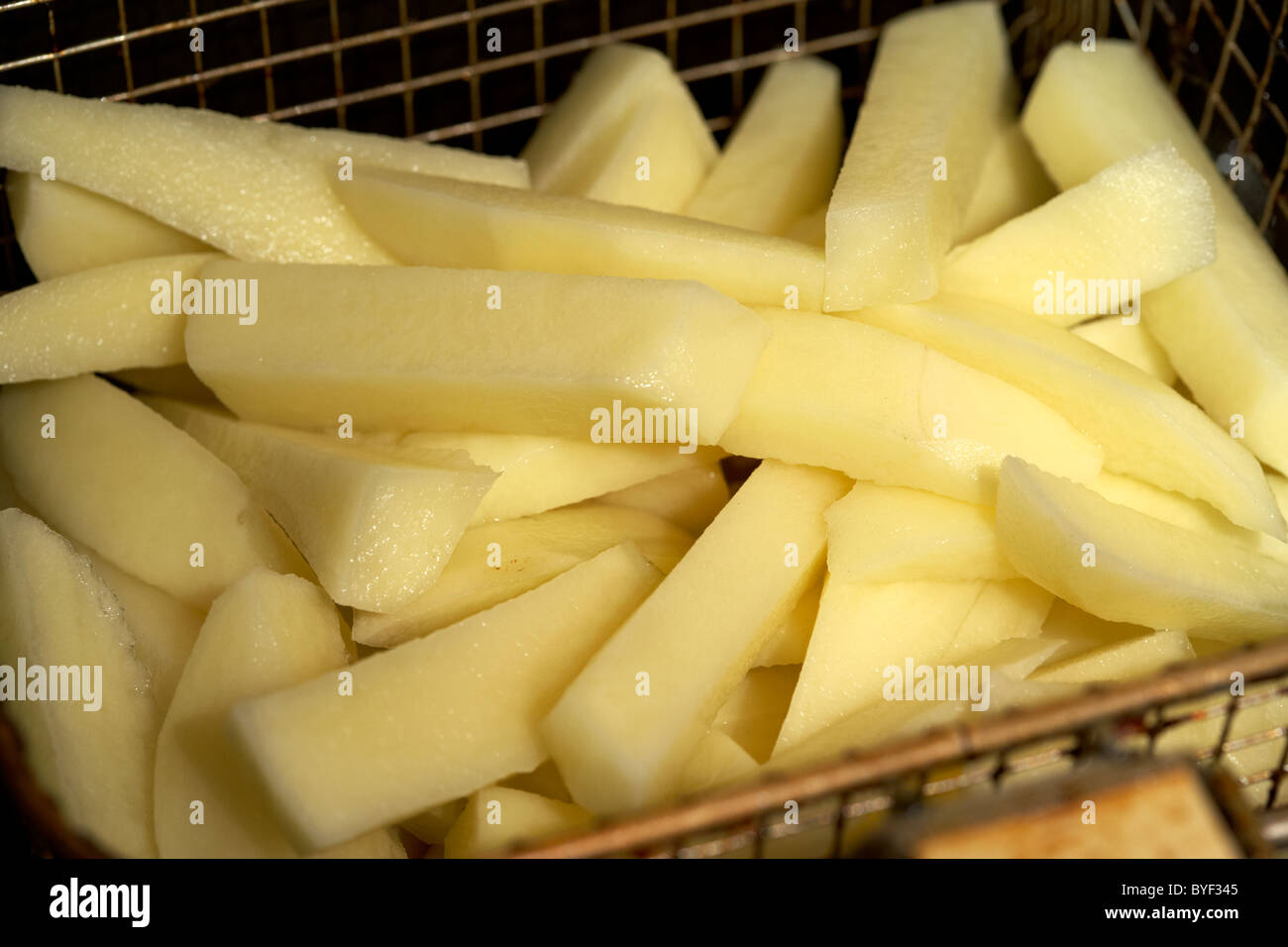 raw sliced cut home made chips from fresh potatoes Stock Photo