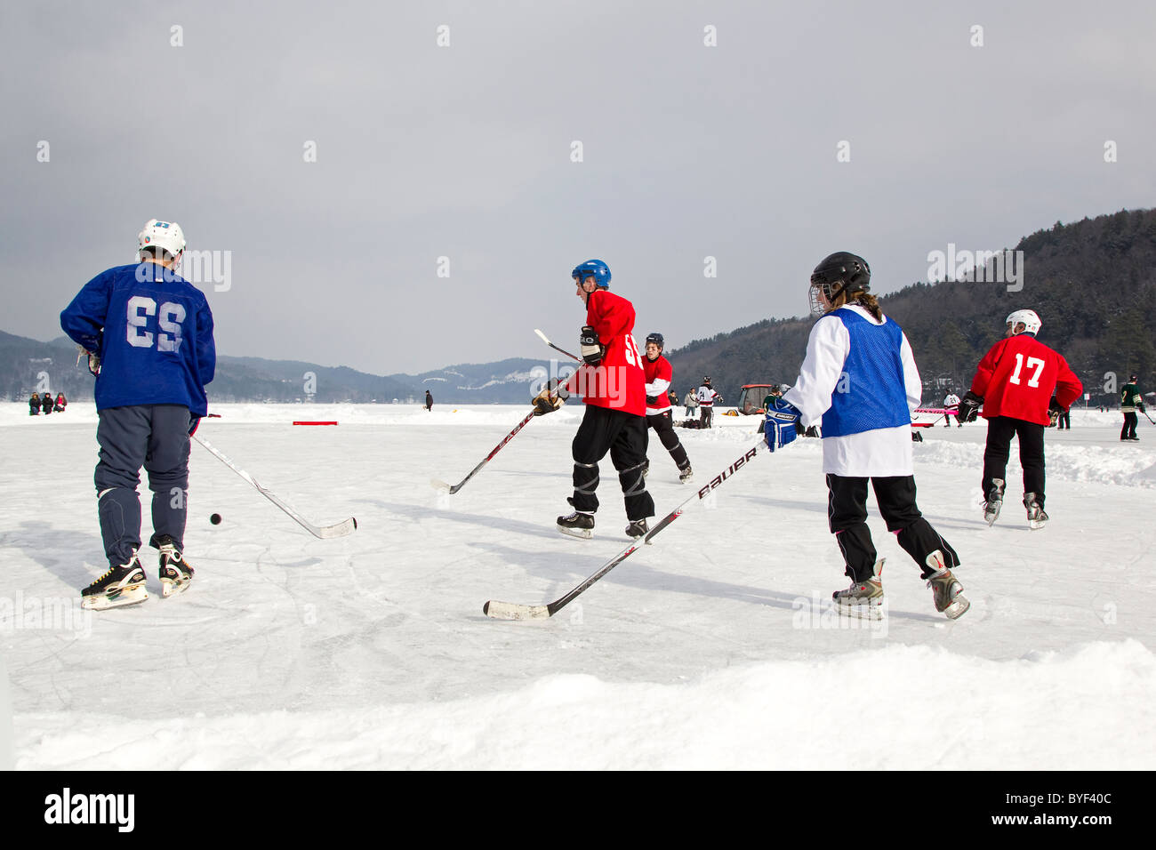 Hockey players play ice hockey in pond hockey tournament, Fairlee, Vermont, New England, USA Stock Photo