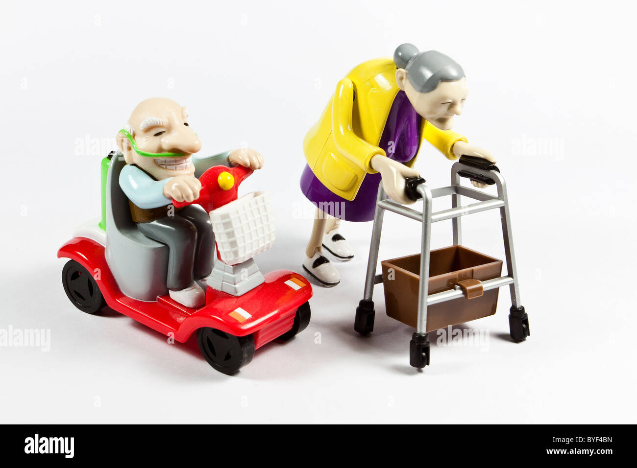 Plastic toys depicting old couple with mobility aids Stock Photo