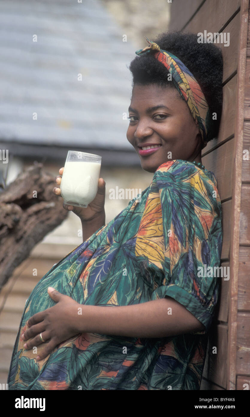 pregnant african woman drinking milk Stock Photo