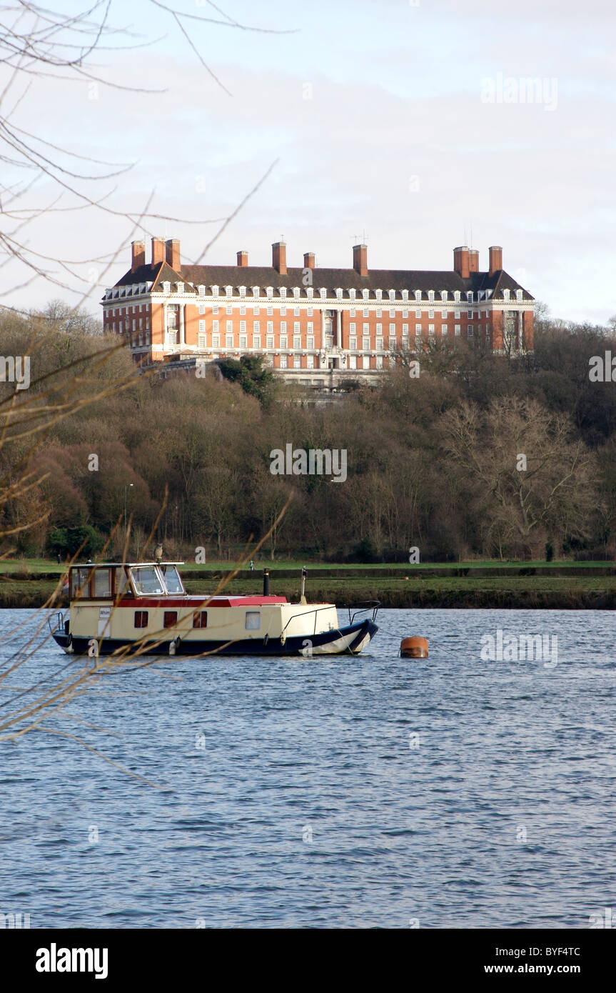 A houseboat on the Thames sits in front of The Royal Star and Garter Home Richmond Stock Photo