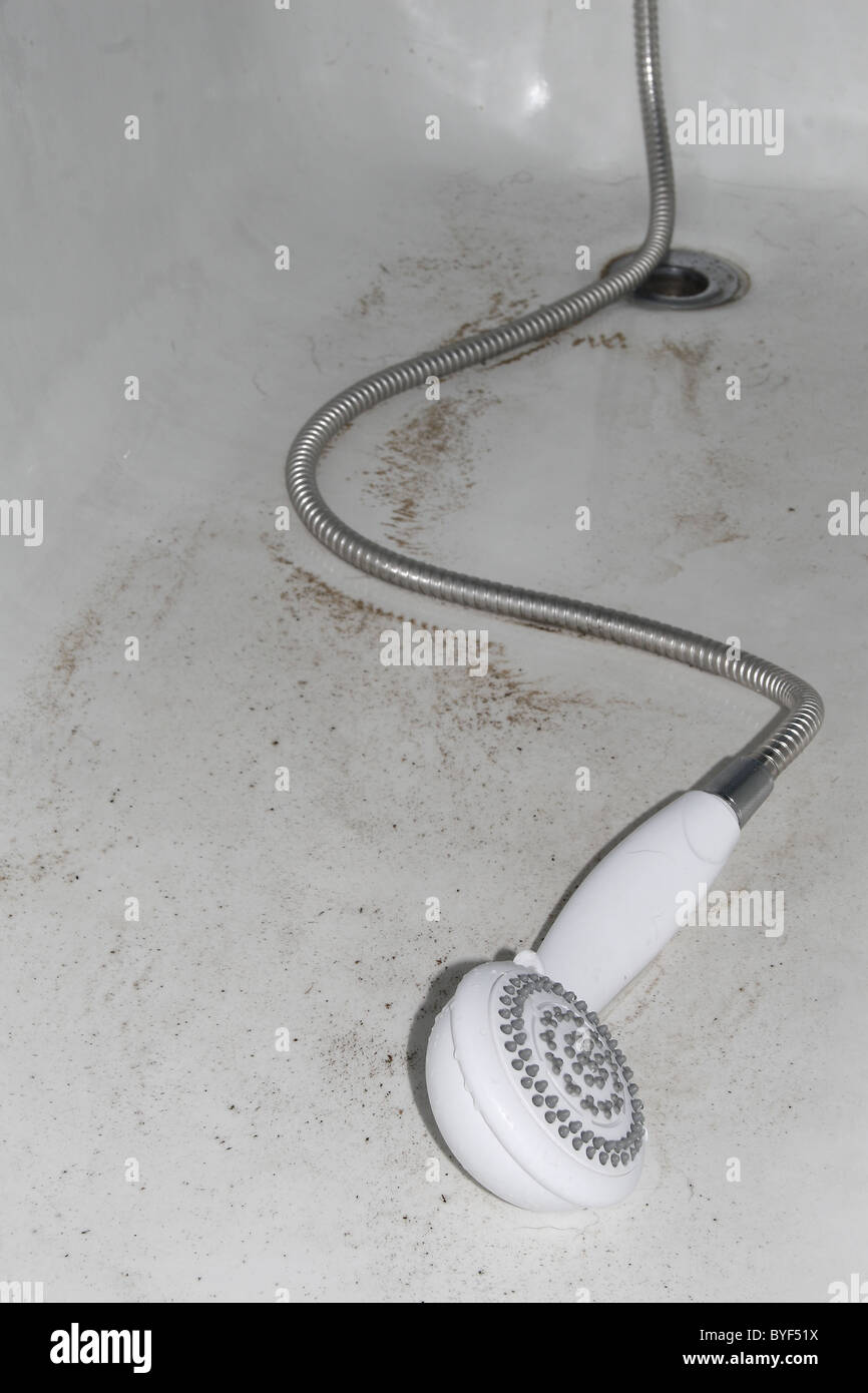 shower head and dirt in bath Stock Photo