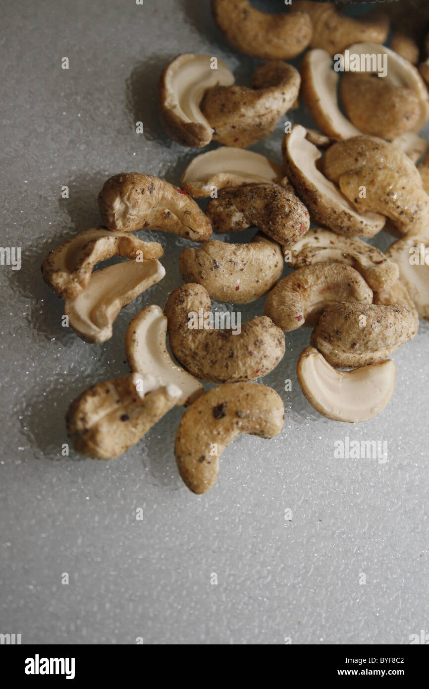 image of cashews covered in sea salt and cracked black pepper Stock Photo