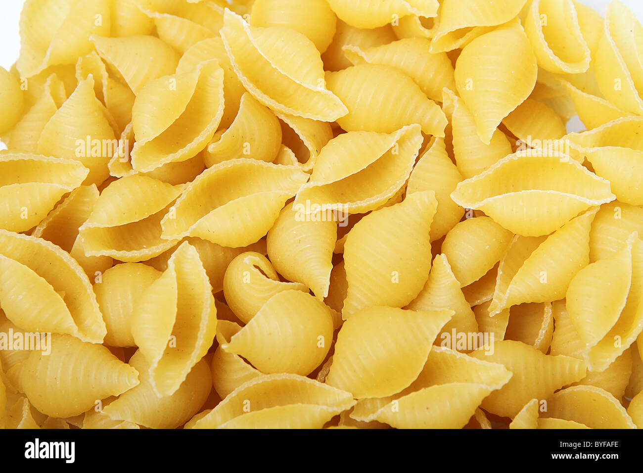 Close-up of uncooked golden yellow pasta Stock Photo