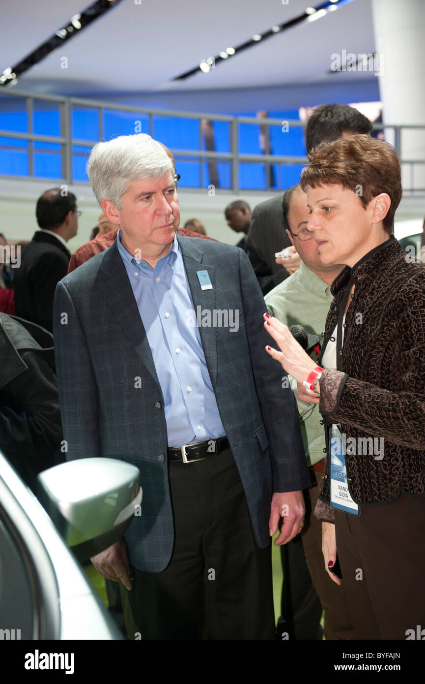 Nancy Gioia, Ford's Director of Global Electrification, shows Michigan Governor Rick Snyder an electric Ford at the 2011 NAIAS Stock Photo