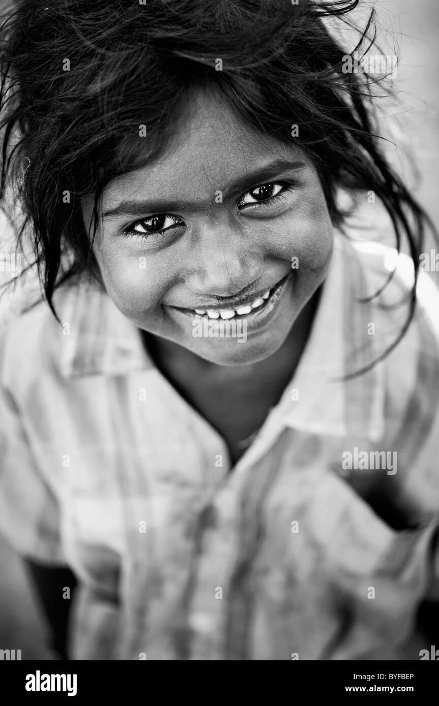 Happy young poor lower caste Indian street girl smiling. Andhra Pradesh, India. Monochrome Stock Photo
