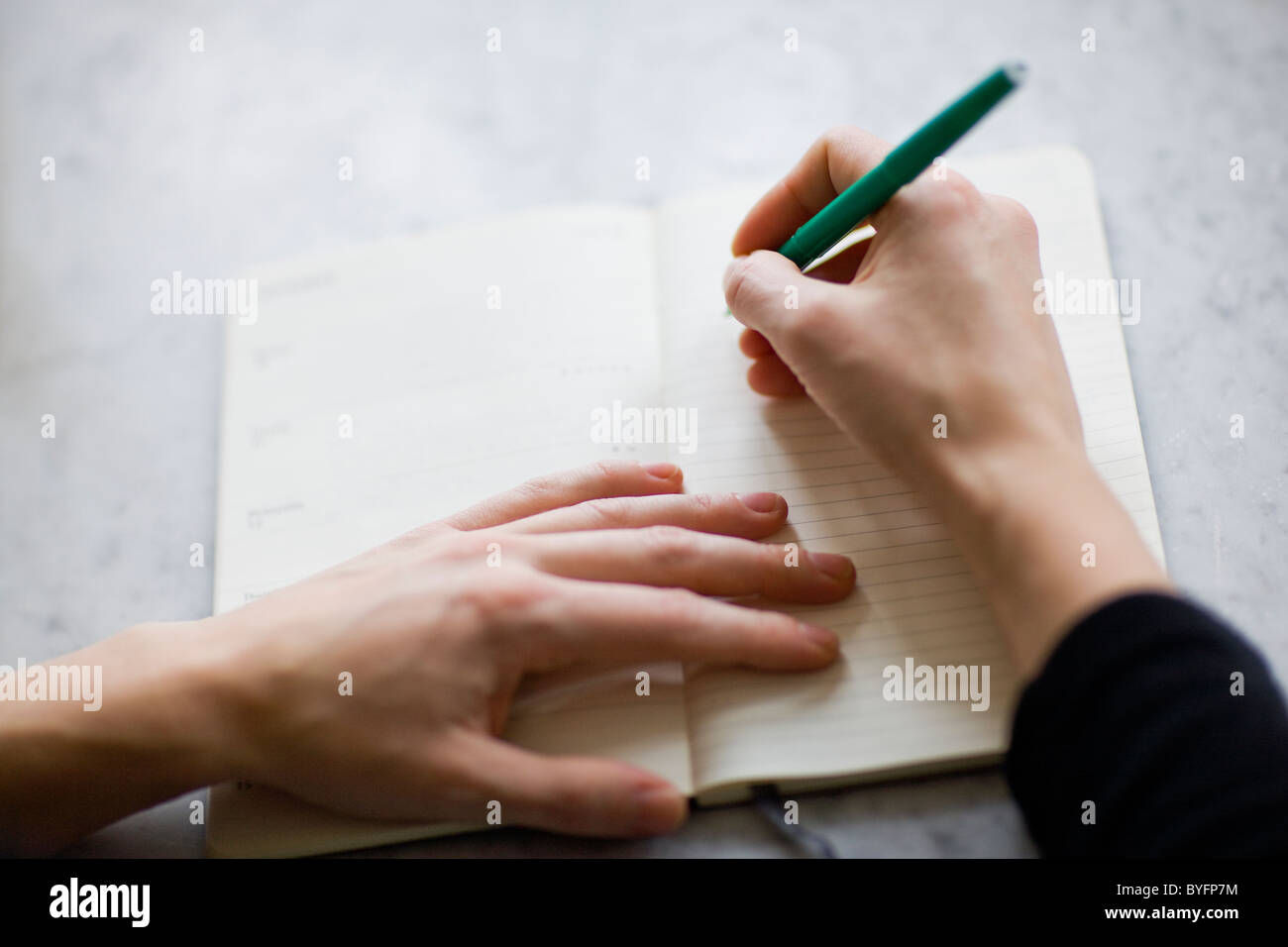 Woman writing on diary Stock Photo