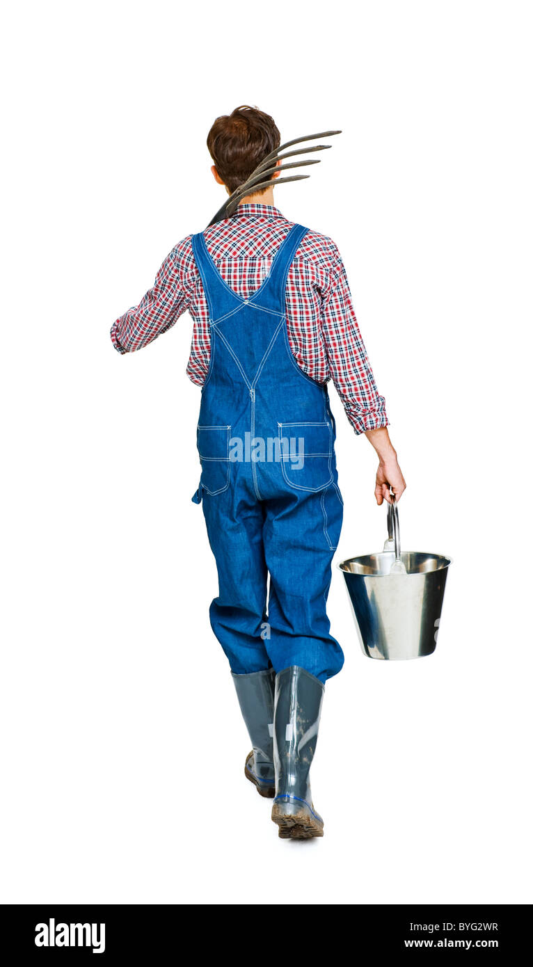 Studio shot of farmer with pitchfork and bucket Stock Photo