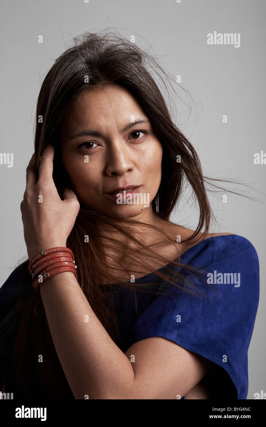 Portrait of woman against grey background Stock Photo - Alamy