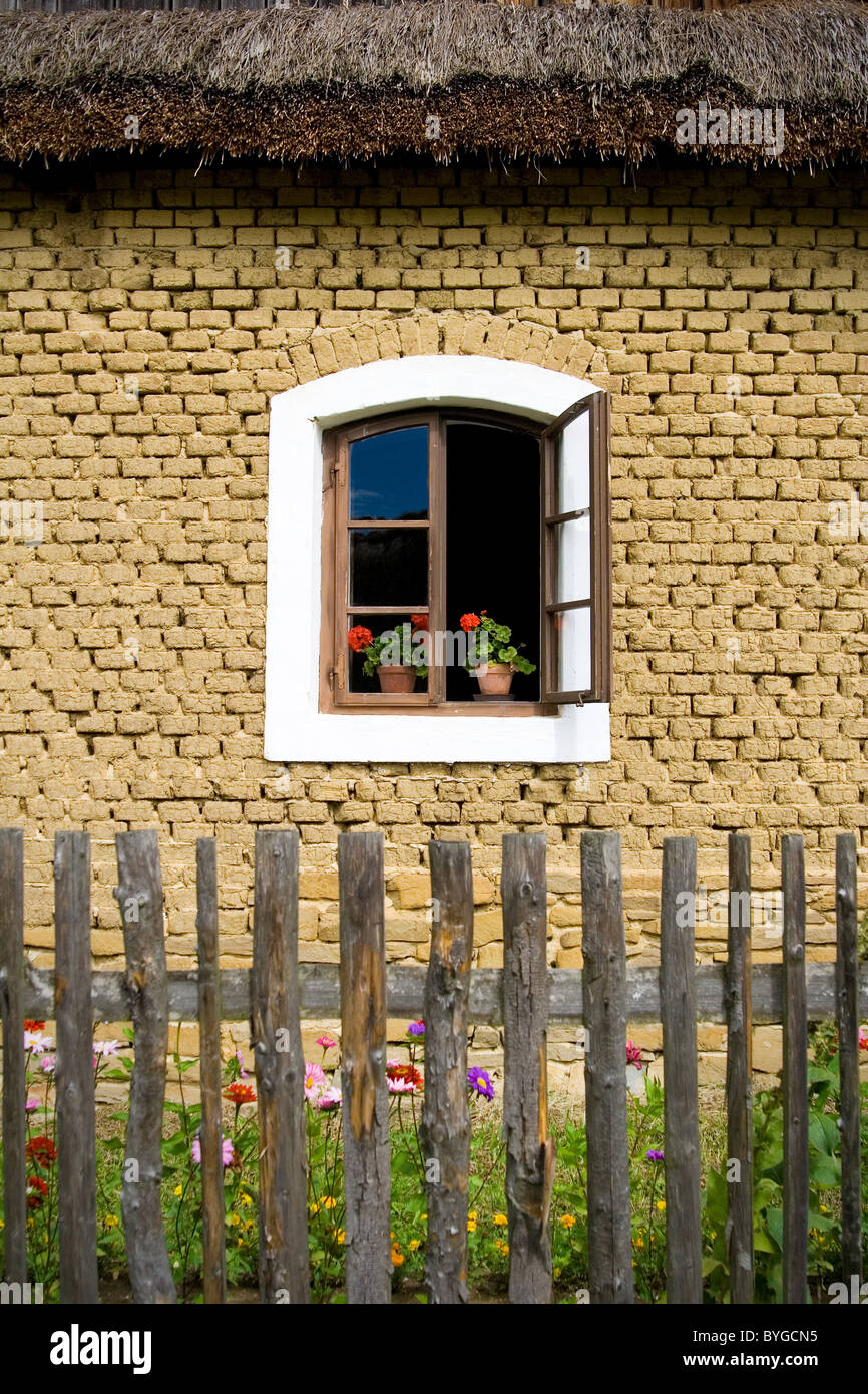 the open window with flower in pot on old house Stock Photo