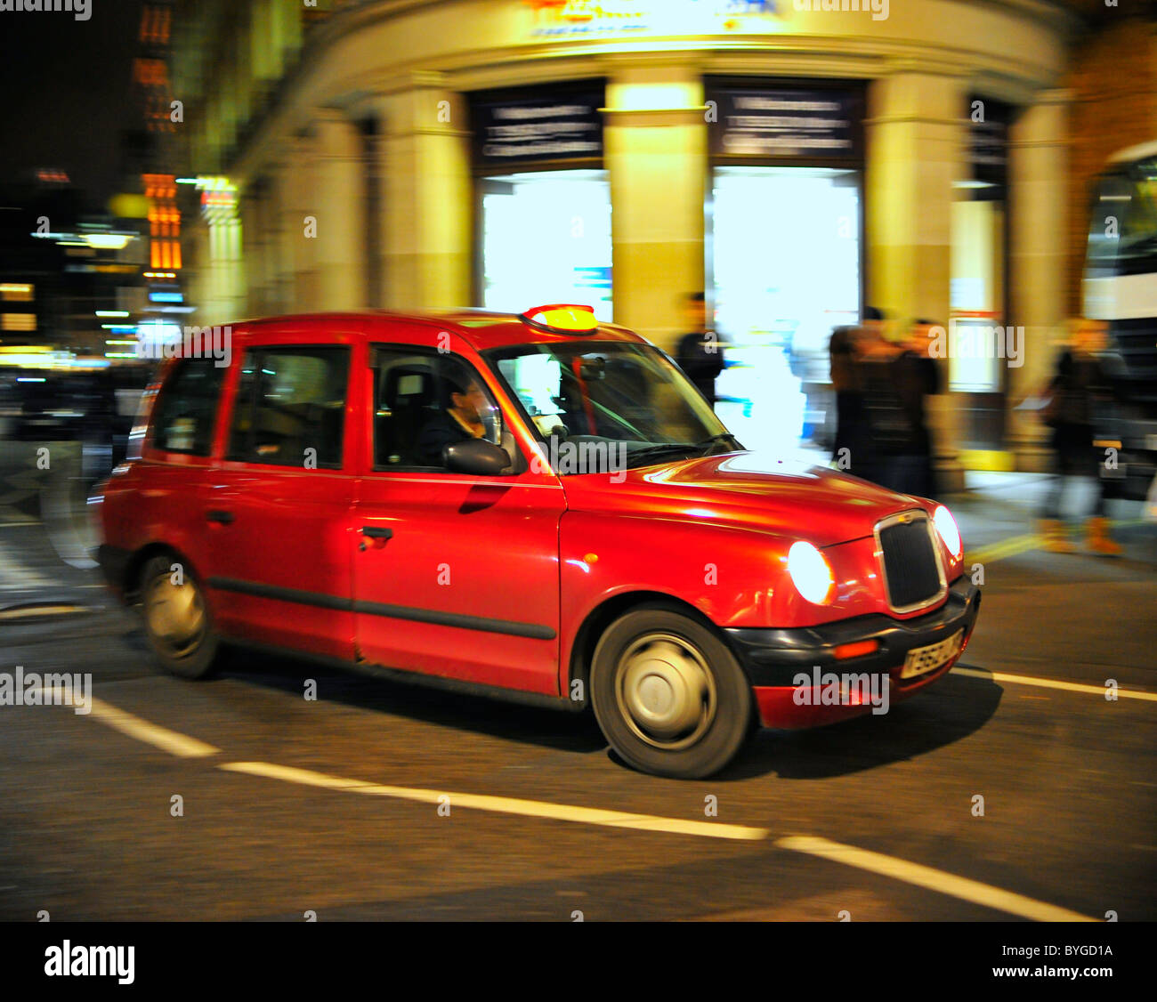 Red Taxi Cab in motion on the streets of London Stock Photo