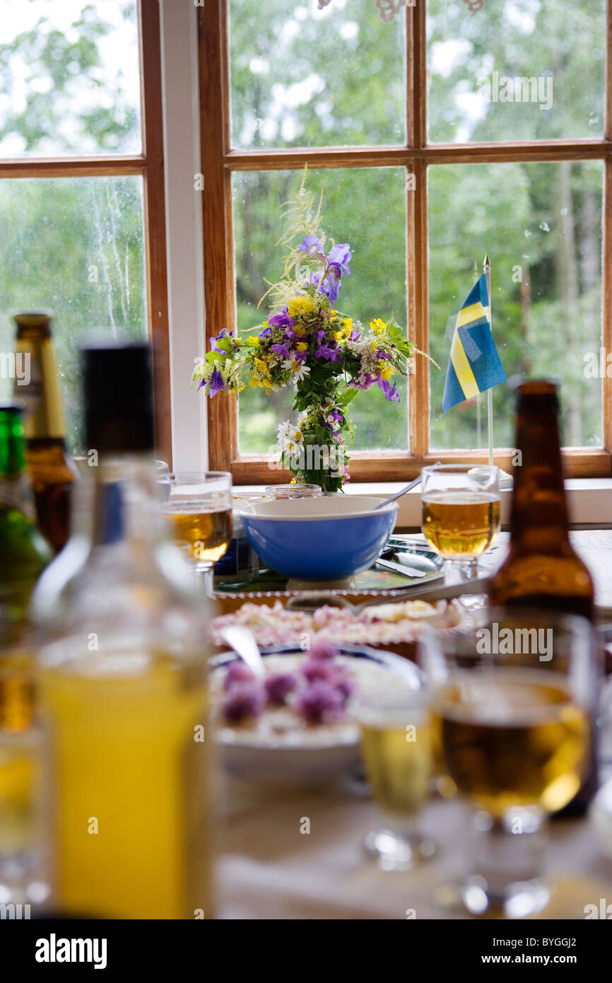 Dinner setting on table with Swedish flag and flower vase Stock Photo
