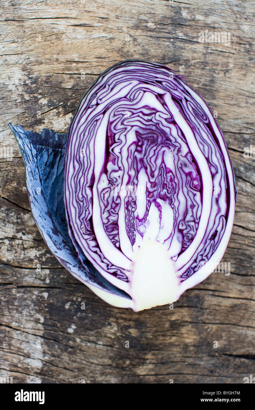 Overhead view of half of red cabbage on wooden table Stock Photo