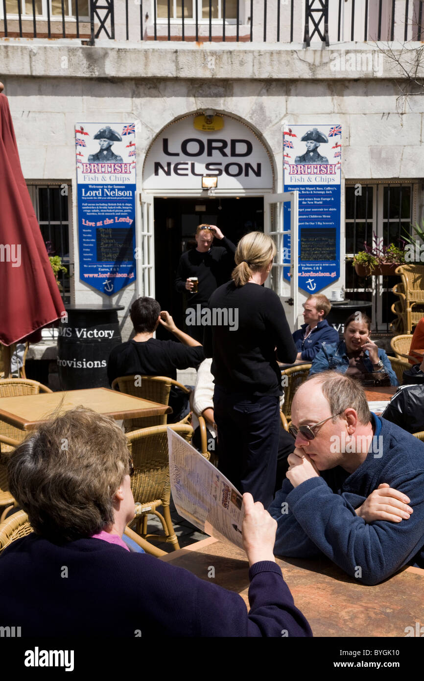 People choosing meals / food / drink from menu at outdoor restaurant tables outside The Lord