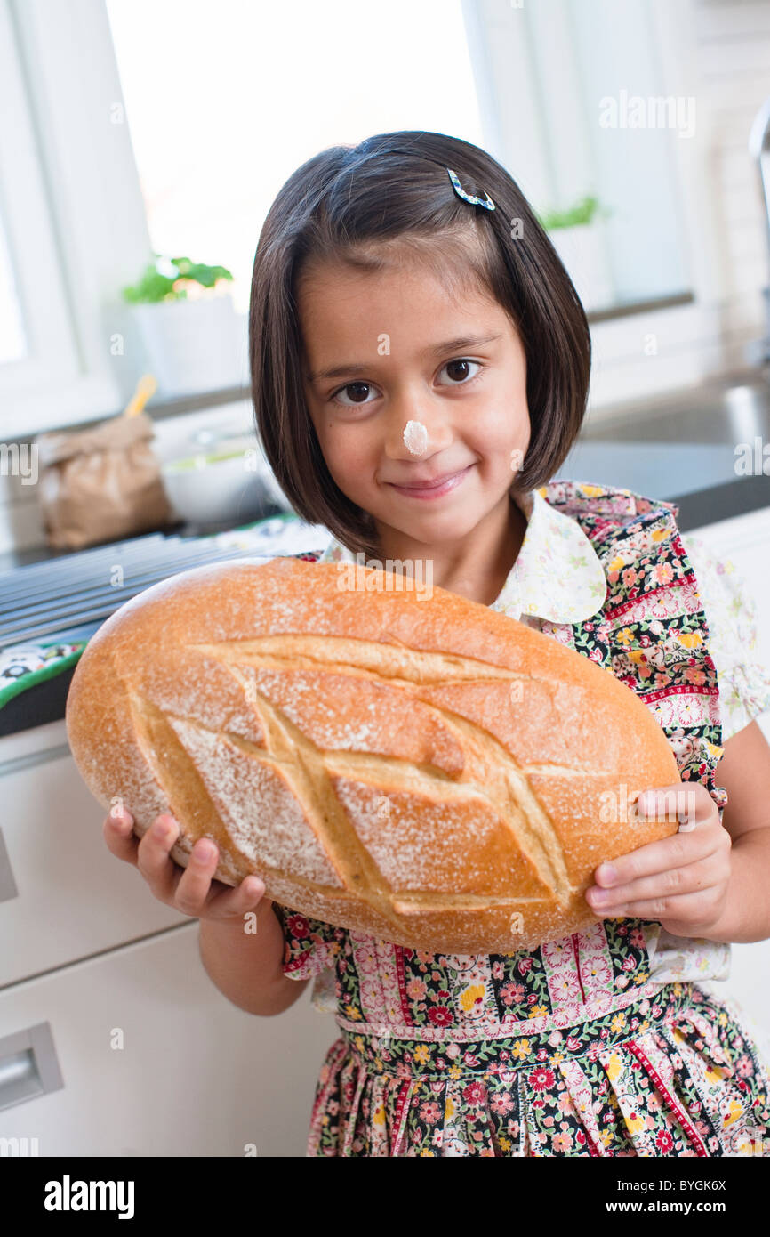 Portrait of girl holding freshly mad bread Stock Photo Alamy