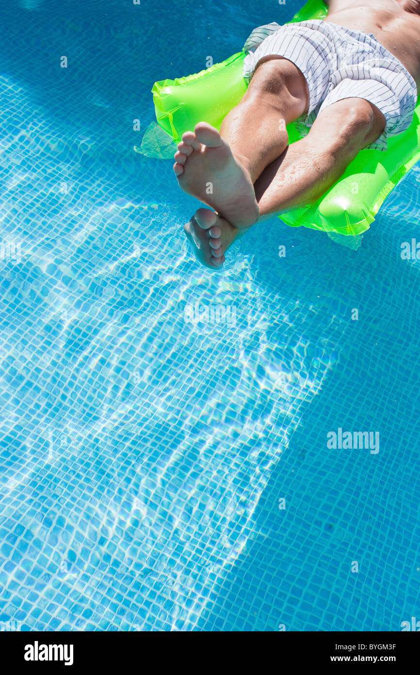 Man on inflatable raft in swimming pool Stock Photo Alamy